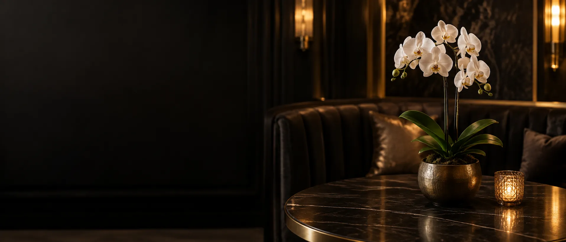 A single white orchid resting on a quiet VIP booth table, a reminder to pause and take stock
